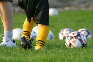 Cleated Feet and a Bunch of Soccer Balls